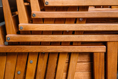 Full frame of stacked wooden chairs