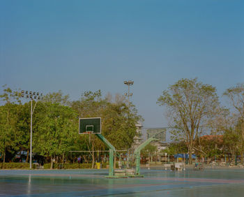 View of basketball hoop against clear blue sky