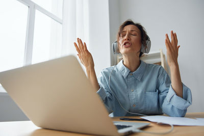 Young woman using laptop at office