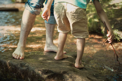 Low section of people standing on land