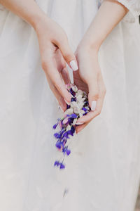 High angle view of woman hand holding white flower