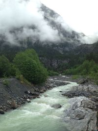 Scenic view of waterfall against sky