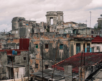 Old buildings in city against sky