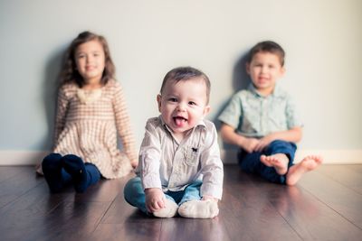 Portrait of happy friends sitting at home