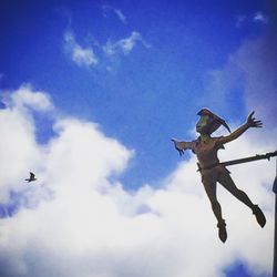 Low angle view of bird flying against blue sky