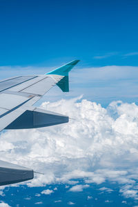 Cropped image of airplane wing against sky