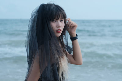 Young woman standing at beach