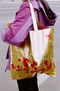 Midsection of woman holding red umbrella