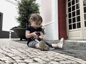 Boy playing on cobblestone