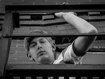 Portrait of boy seen through railing