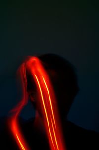 Close-up of illuminated candle against black background