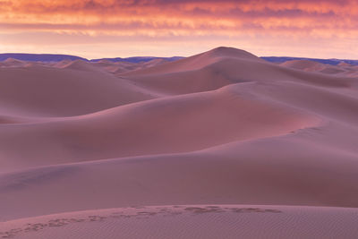 Scenic view of desert against sky during sunset
