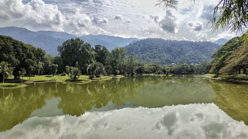 Scenic view of lake and mountains against sky