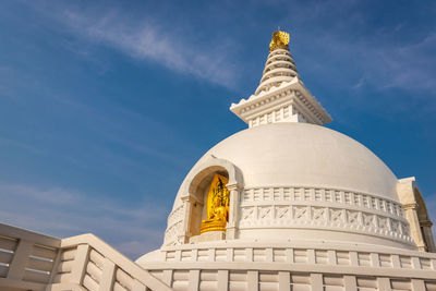 Buddhist stupa isolated with amazing blue sky from unique perspective