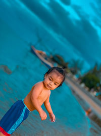 Full length of shirtless boy in swimming pool