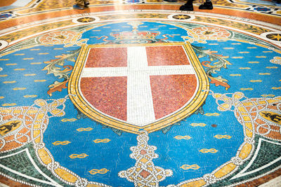 High angle view of cross on tiled floor
