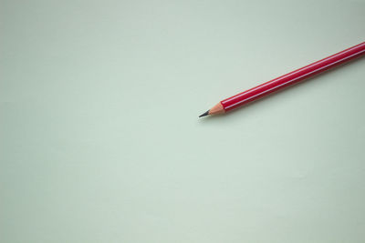 High angle view of colored pencils against white background