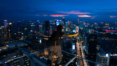 Aerial view of illuminated city buildings at night