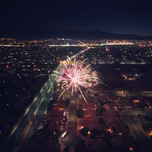 High angle view of firework display at night