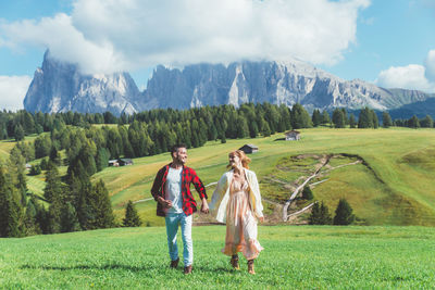 Women on field against mountains