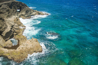 High angle view of rocky cliffs by the ocean