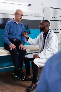 Doctor showing medical x-ray to patient