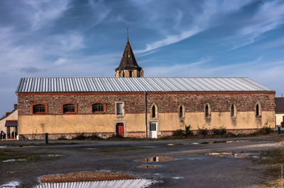 Exterior of building against cloudy sky