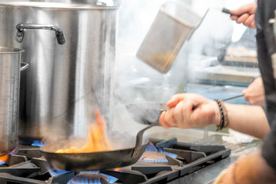 Midsection of man preparing food in kitchen