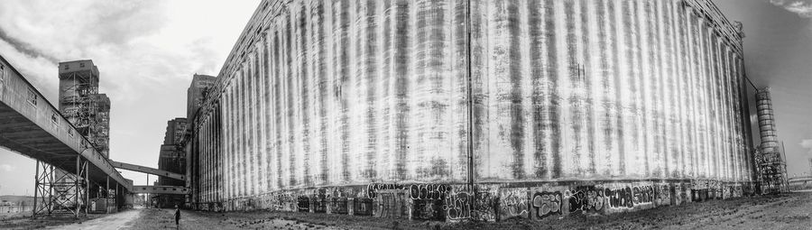 Buildings against cloudy sky