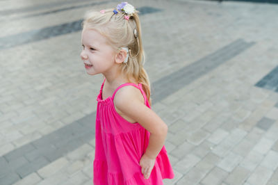 Side view of young woman standing on street