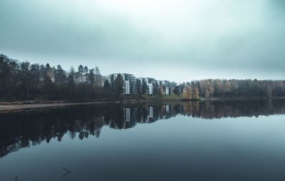 Reflection of trees in lake against sky