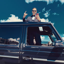 Low angle view of man sitting in car