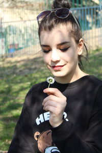 Portrait of teenage girl holding plant