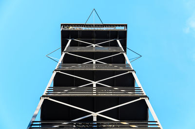 Low angle view of modern building against clear blue sky