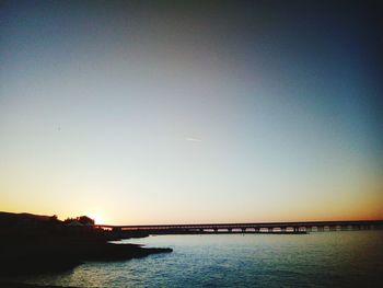 Scenic view of sea against clear sky during sunset