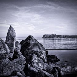 Scenic view of sea against cloudy sky