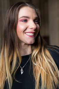 Smiling woman with long hair looking away