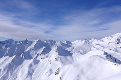 Scenic view of snowcapped mountains against sky