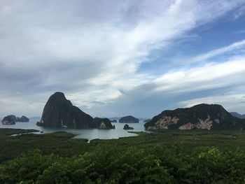 Scenic view of sea and mountains against sky