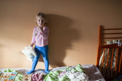 Portrait of cute girl sitting at home