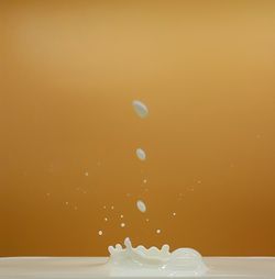 Milk drops on colored background