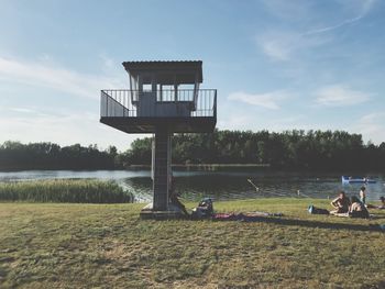 Lifeguard hut on field against sky