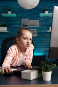 Portrait of young woman sitting at home