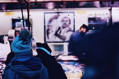 Rear view of person wearing warm clothing at market