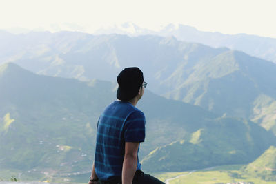 Rear view of man looking at mountains