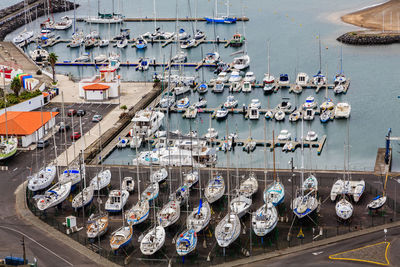 High angle view of sailboats moored at harbor