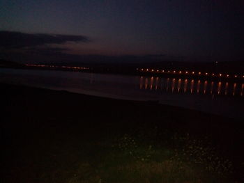 Scenic view of illuminated lights against sky at night