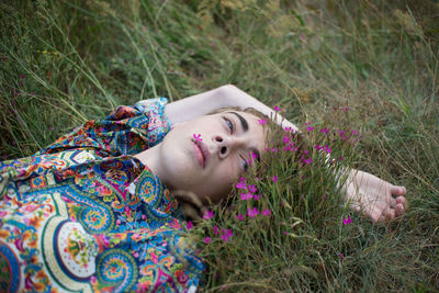 Portrait of woman lying on grass