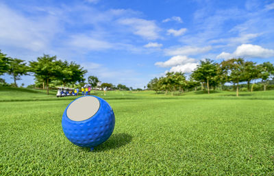 View of golf ball on field against sky