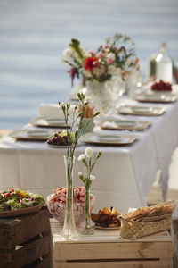 Flowers in vases on table with food